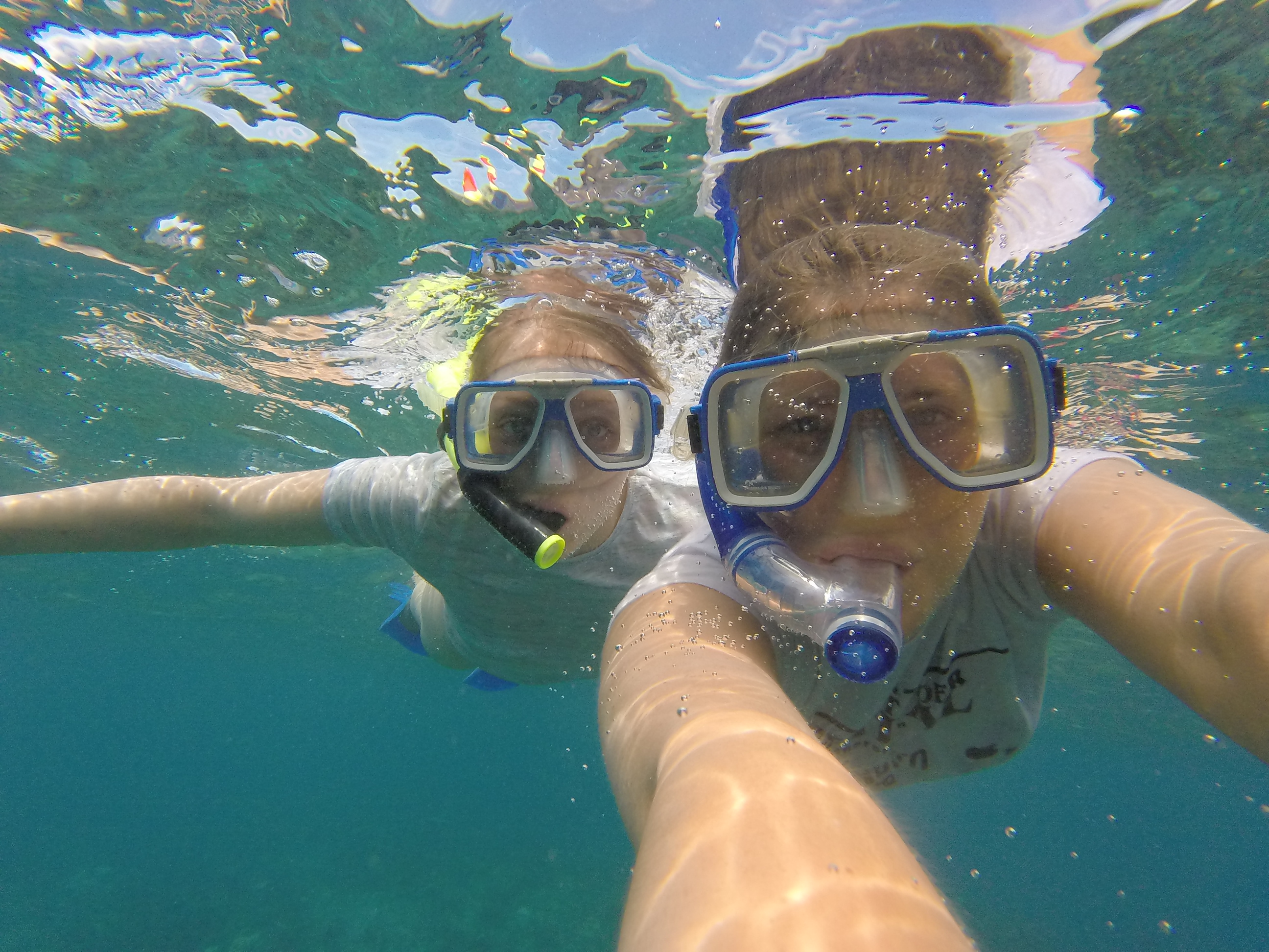 Snorkel seflie using a GoPro while snorkelling with reef sharks in the clear ocean water of Fiji