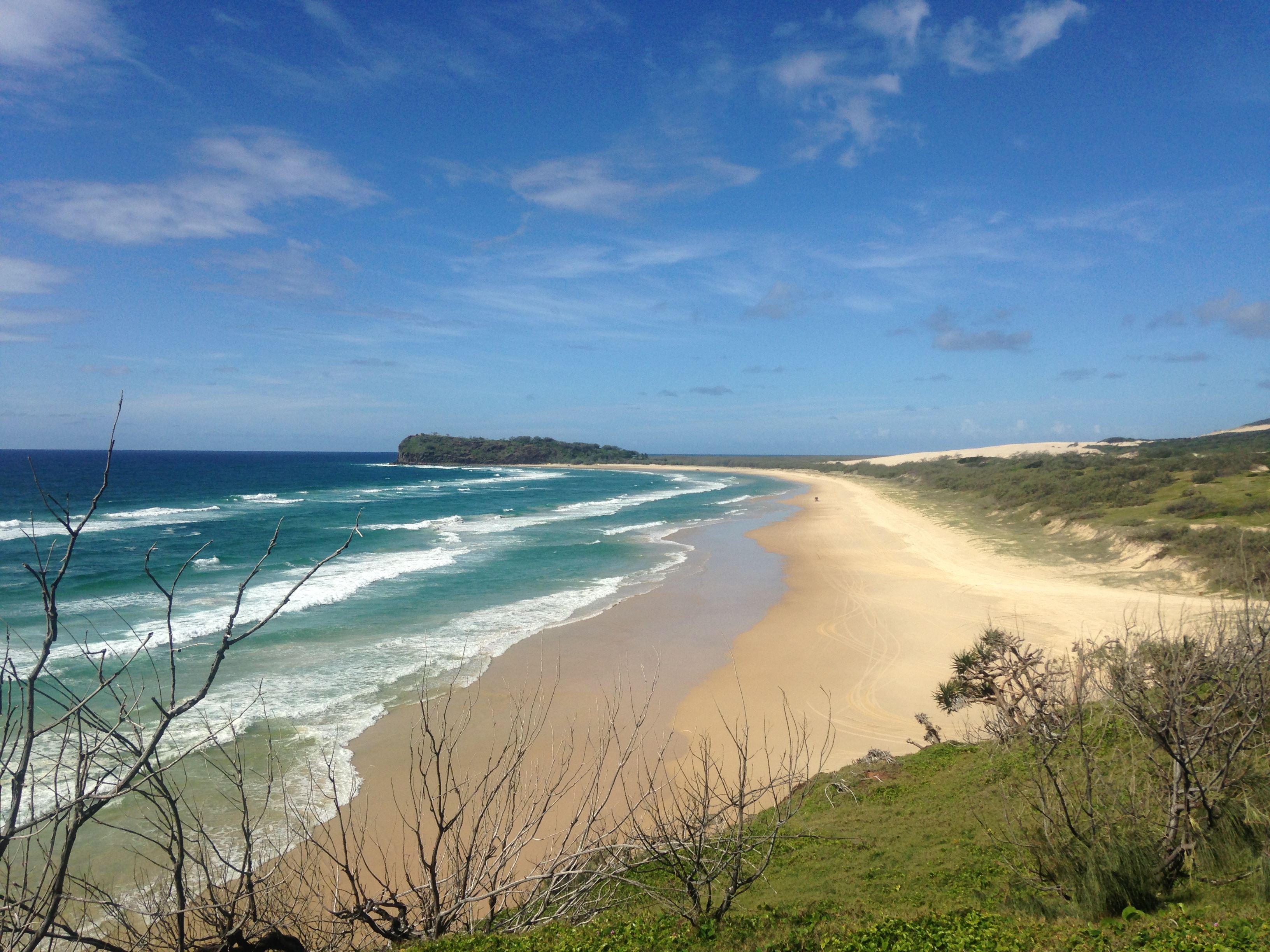 75 Mile Beach on a sunny day with the crashing waves on Fraser Island, Australia