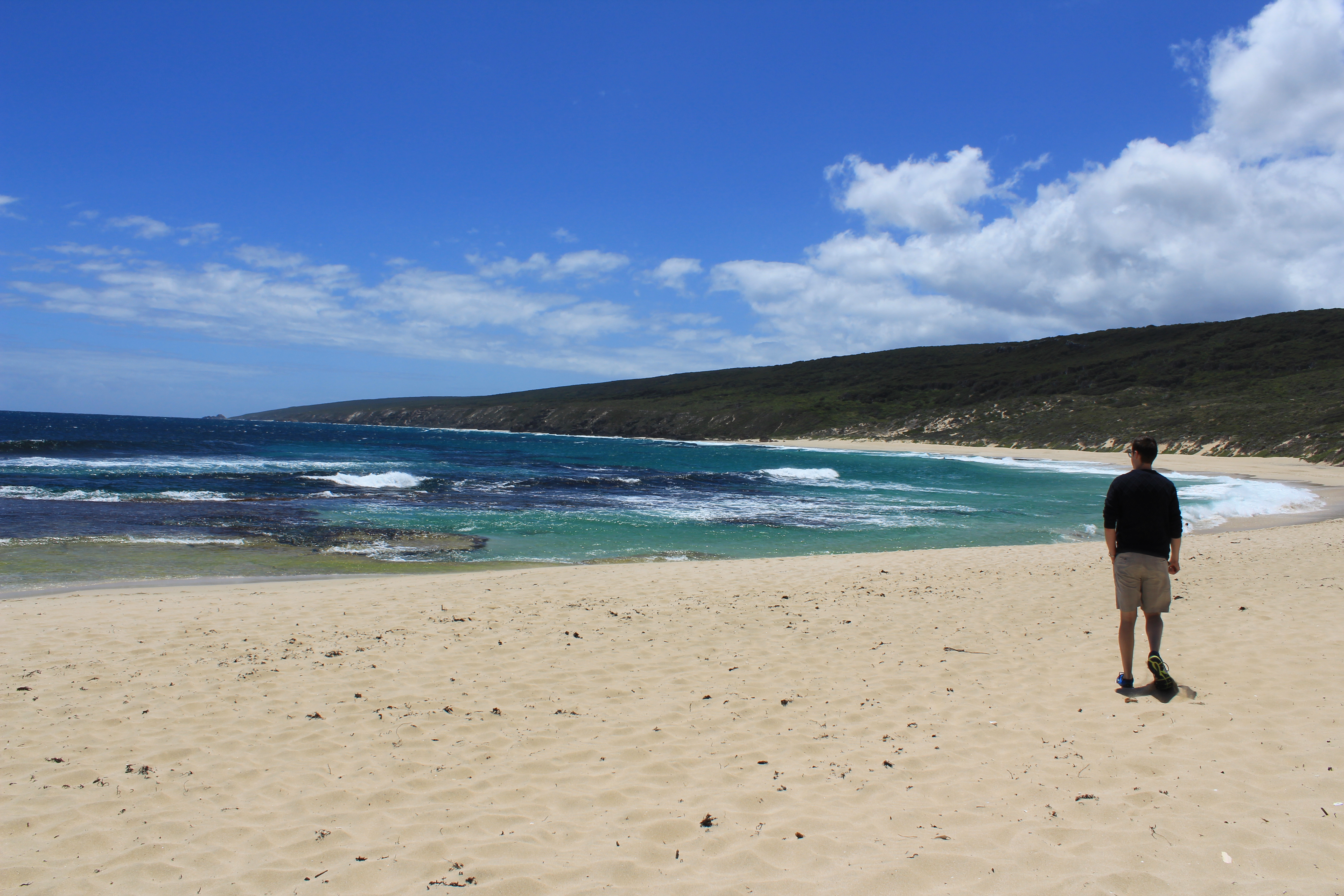 Man walks along the beach at Yallingup Australia