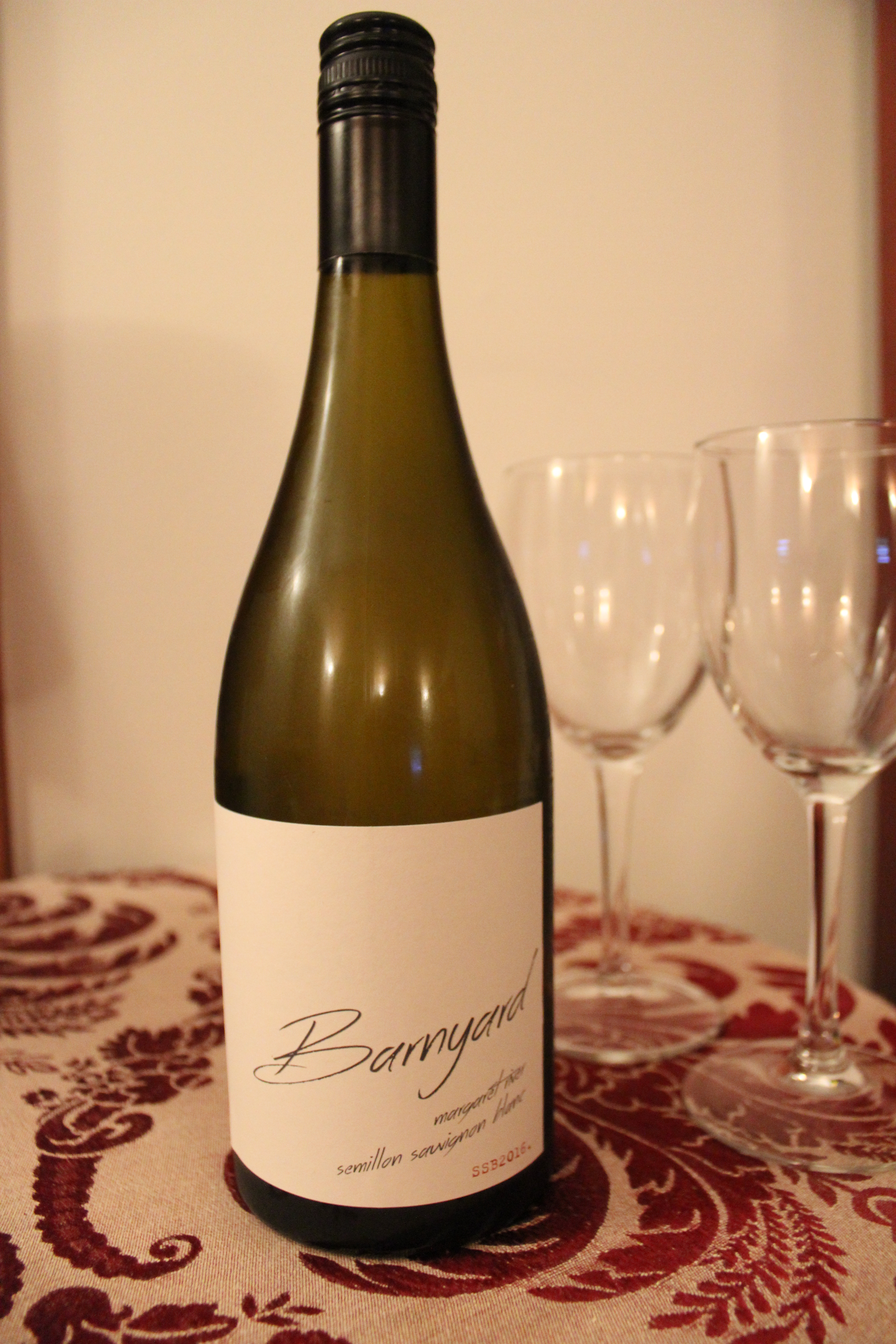 Wine bottle with two glasses behind