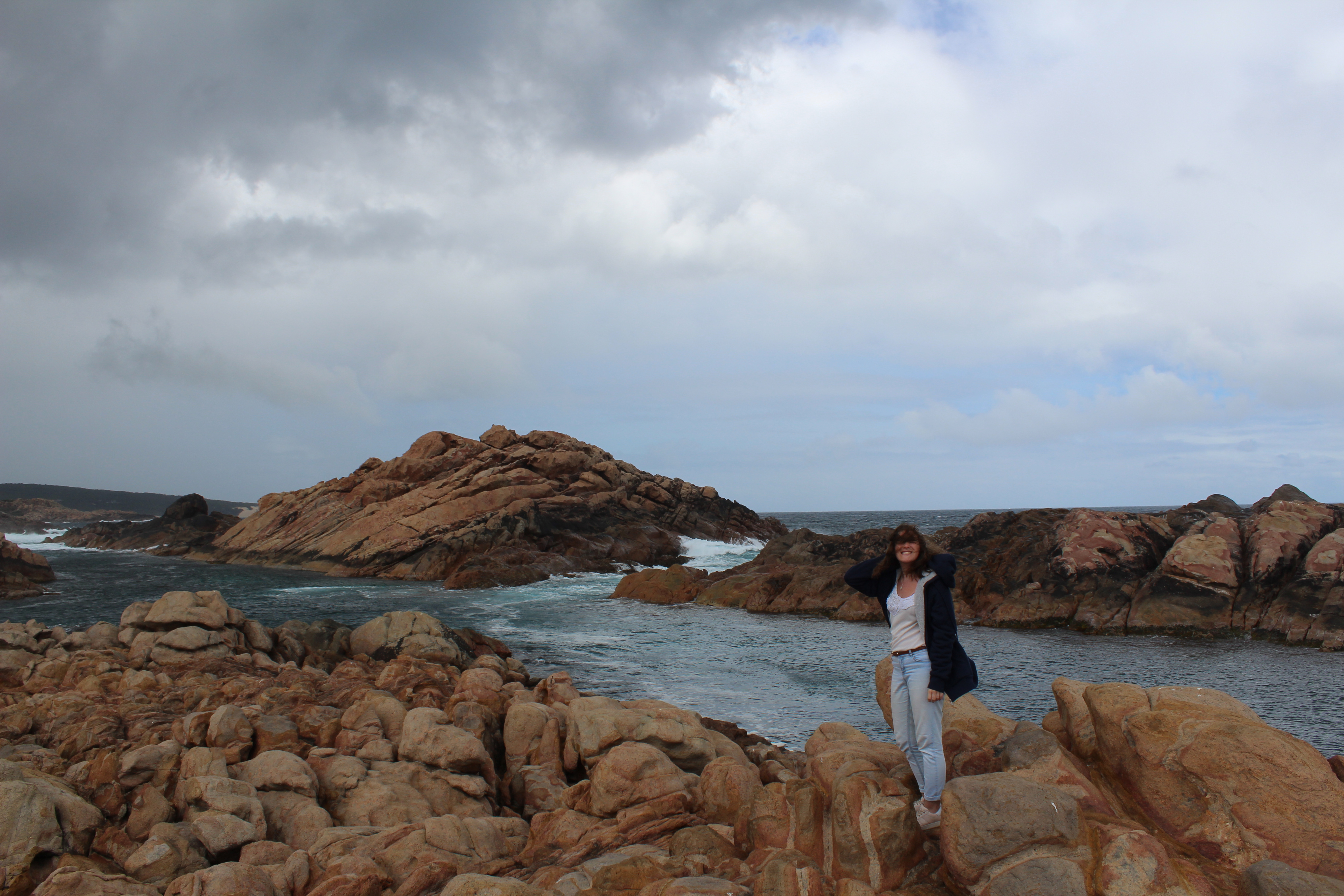 Girl smiles at camera with wind blowing