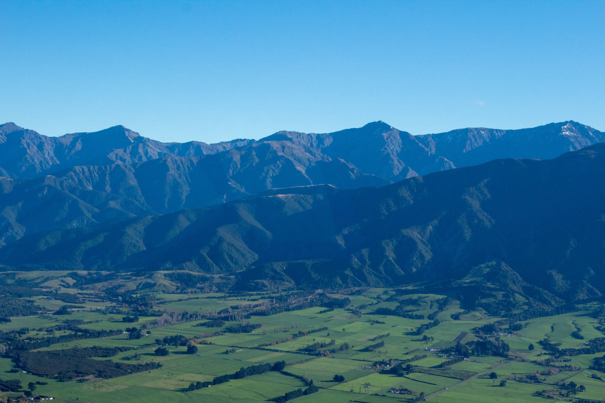 green fields besides mountains