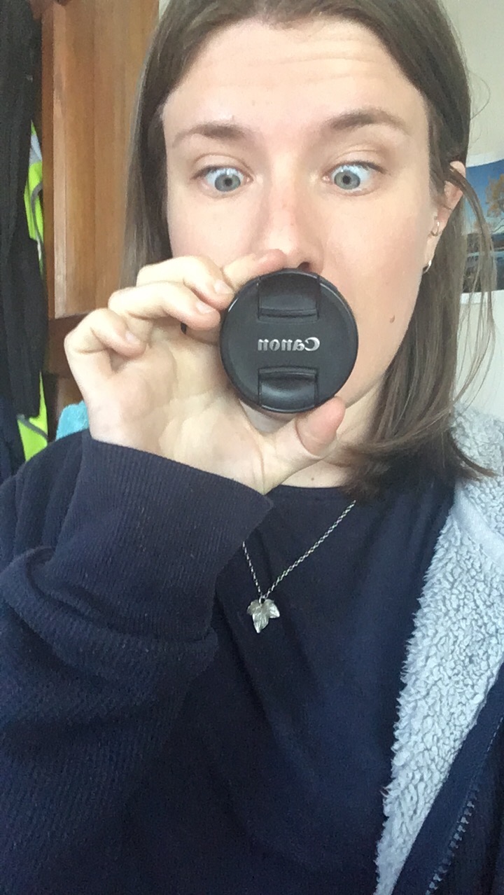 woman holding lens cap
