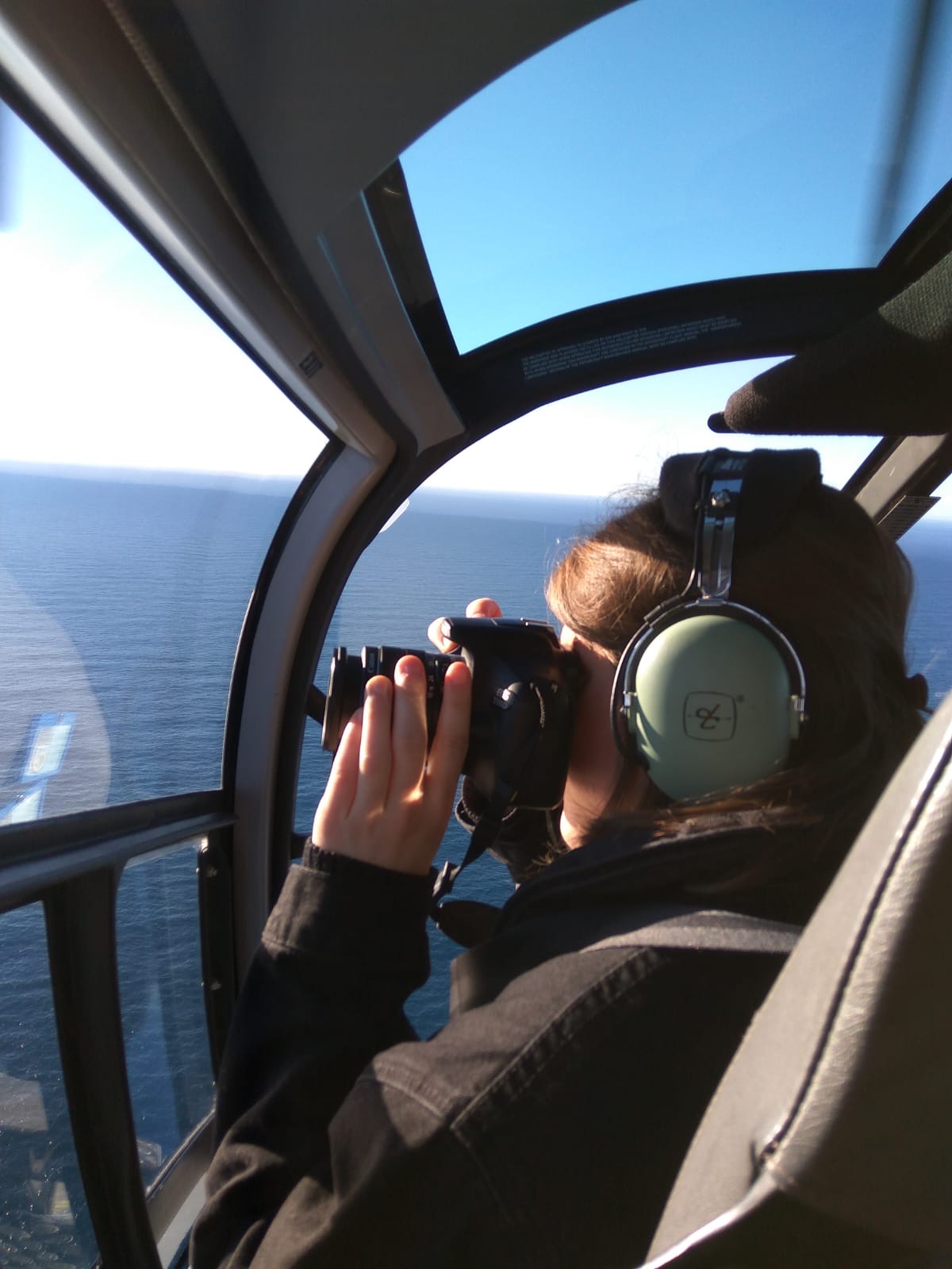 woman takes photo in helicopter
