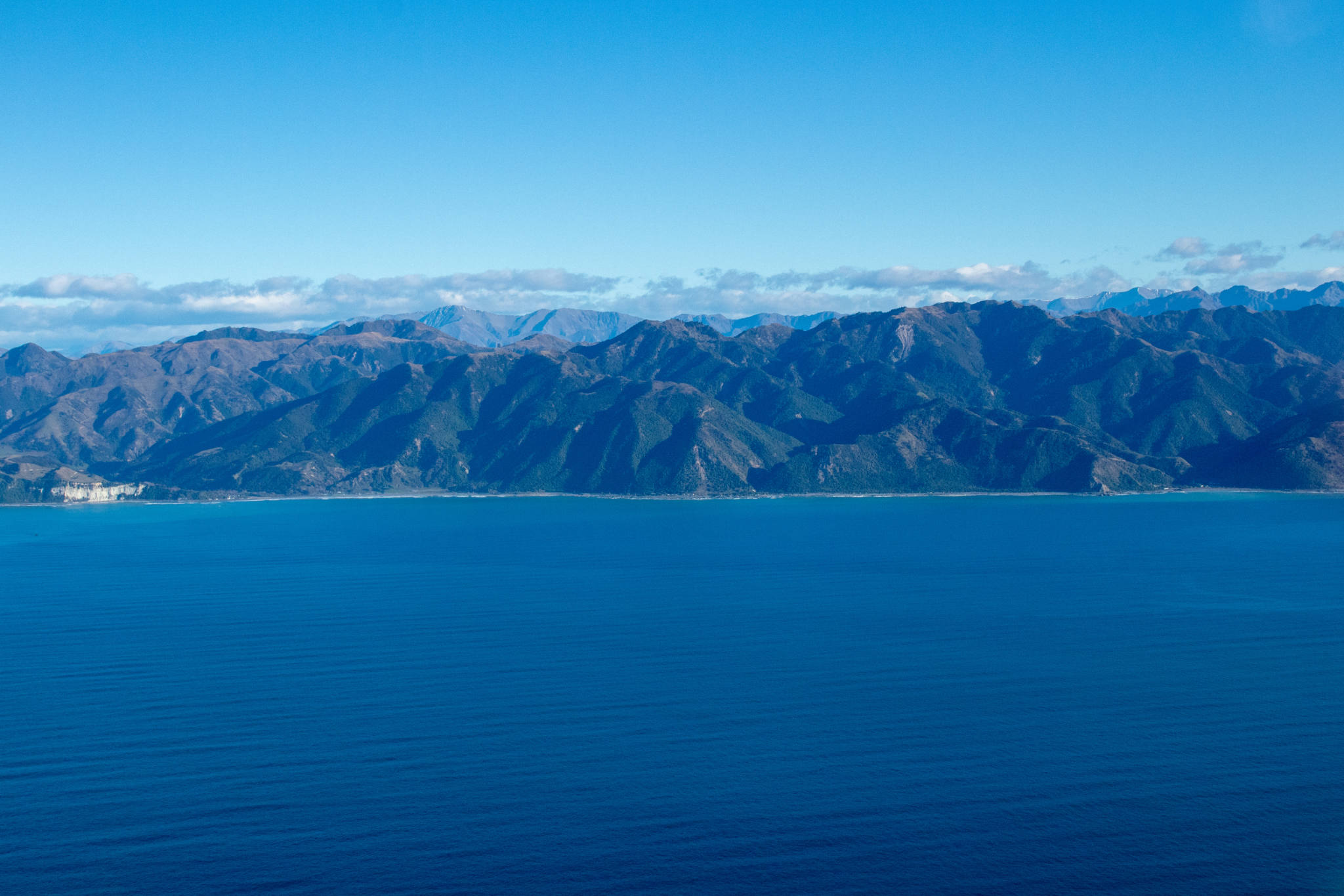 mountain coastline besides ocean