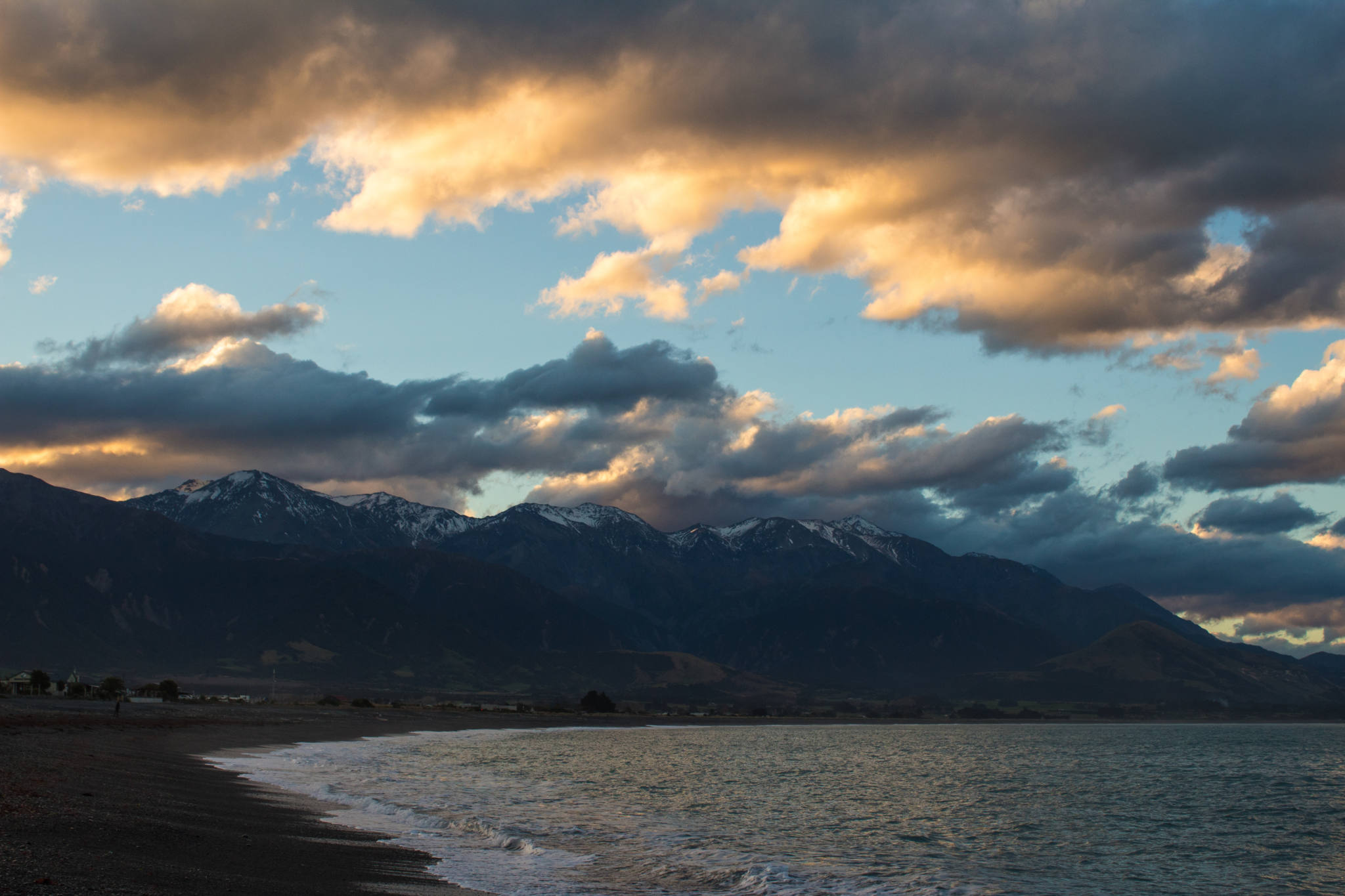 sunset over mountains and beach in kaikoura