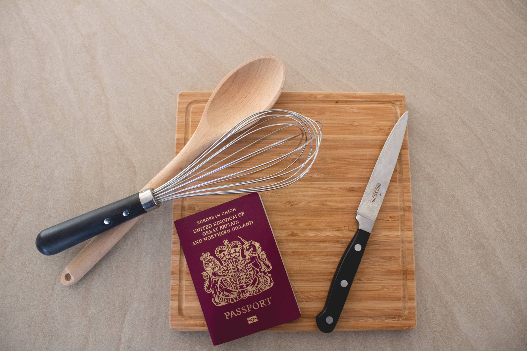Kitchen utensils and chopping board with passport