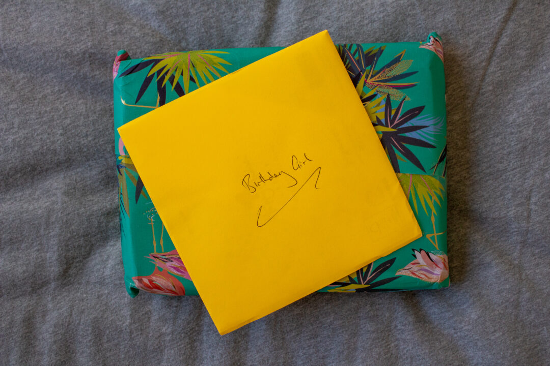 a gift wrapped present and a yellow envelope on top